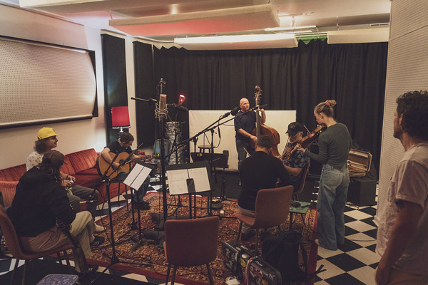 Full ensemble during a Fifty Years of Clown School session — bass, fiddles, mandolin, banjo, all in one room